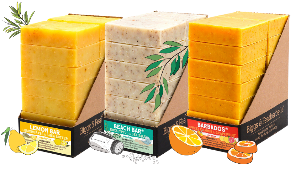 Three stacks of soap bars with packaging featuring lemon, beach, and Barbados scents.